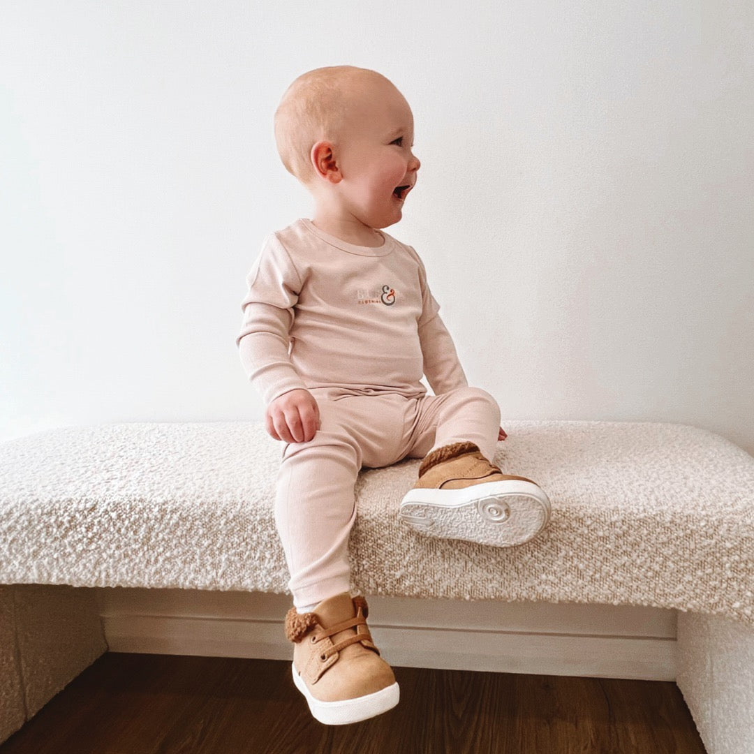 baby sitting in full beige set