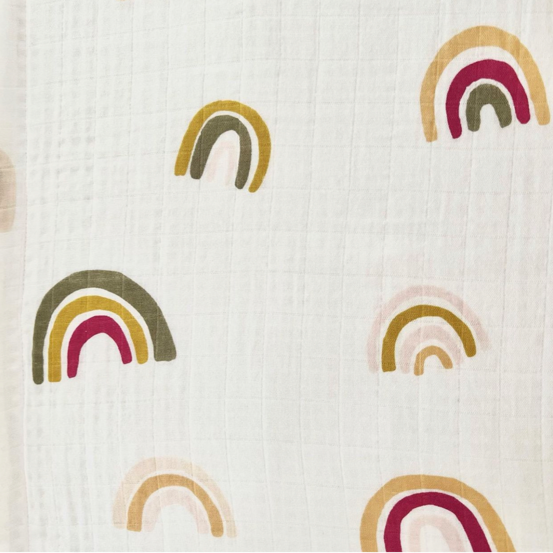 white blanket with green yellow red rainbows