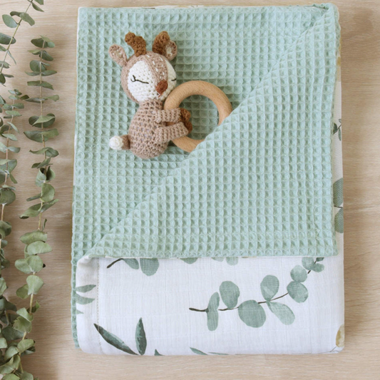 Leaves on white and green blanket